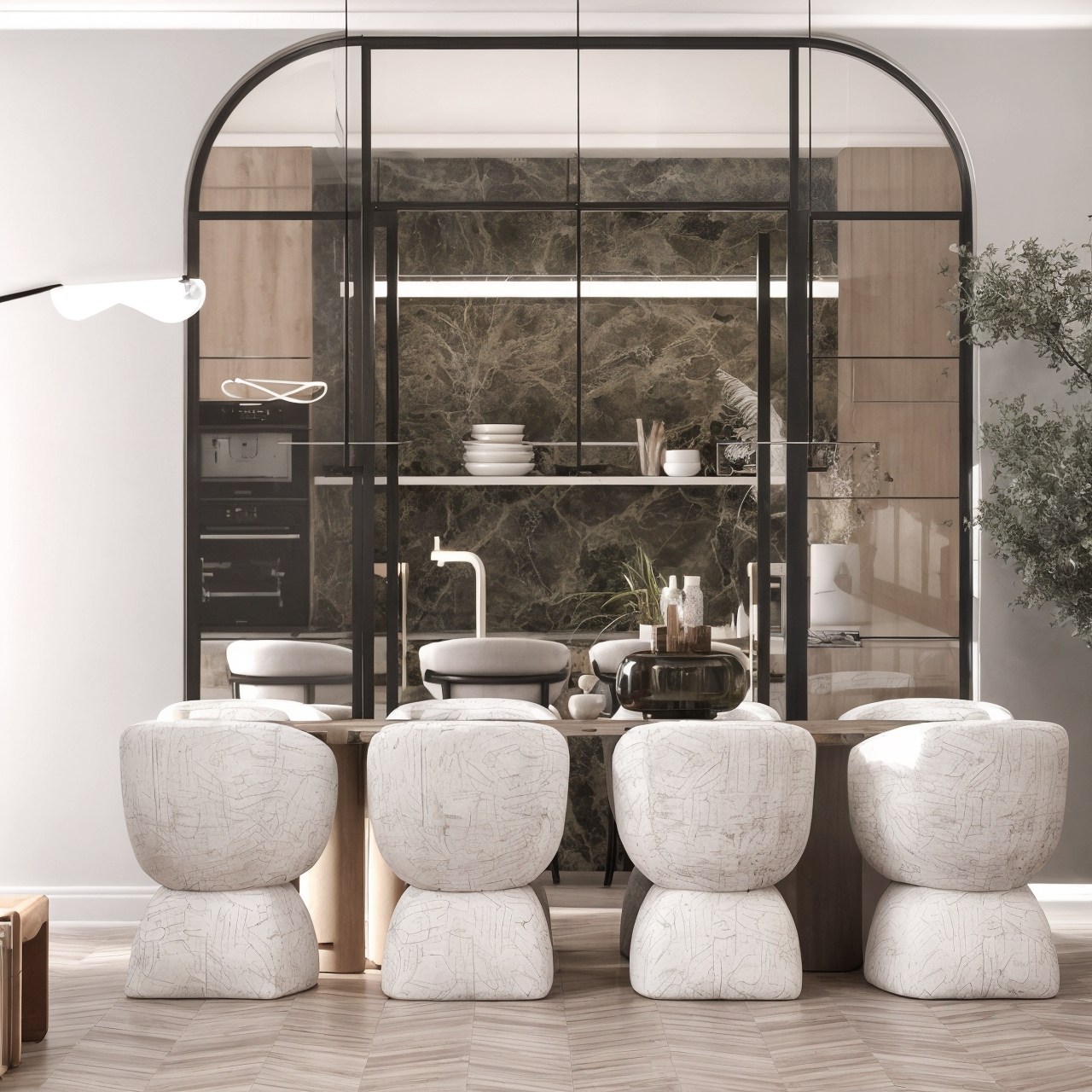 Arched black-framed opening from the dining area toward a dark stone kitchen and four pale stools.