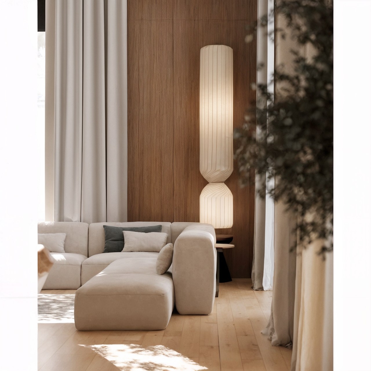 Cream lounge chair and sofa beside vertical timber panelling and a ribbed floor lamp.