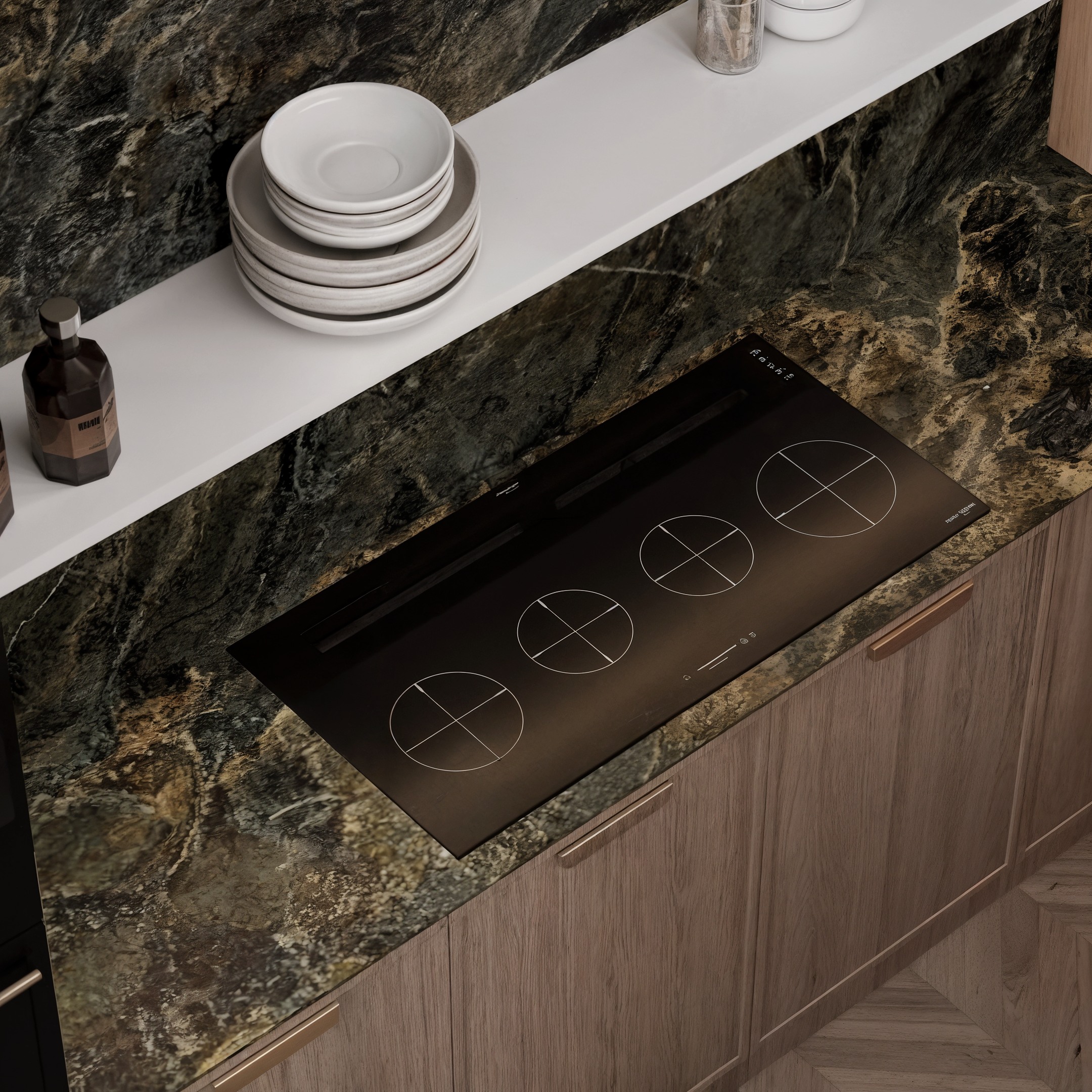 Close-up of an induction hob set into a dark veined stone worktop.