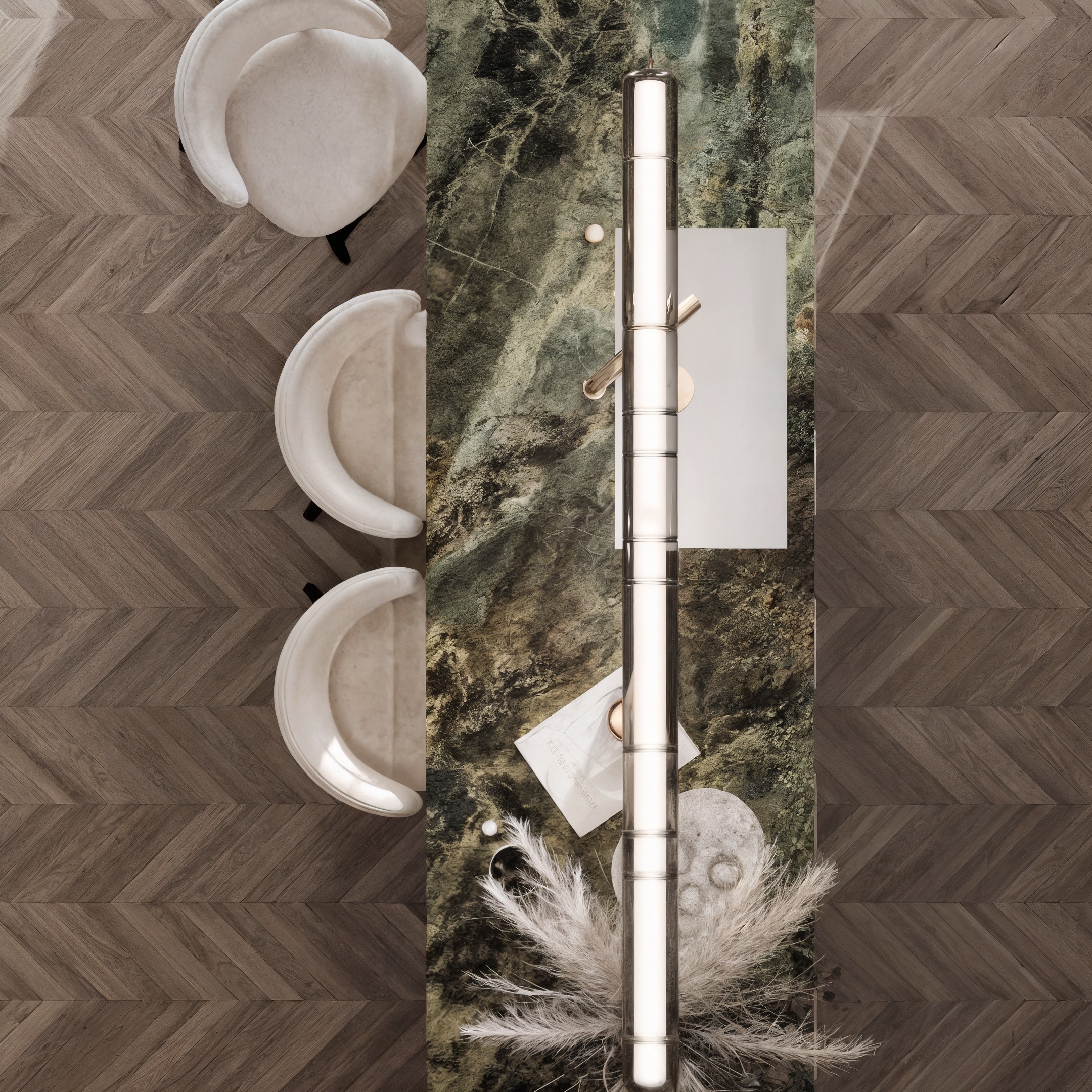 Top-down view of dark stone kitchen island with pale stools and a linear pendant.